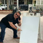 Phill Swift pointing to sign (blank)