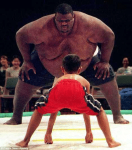 Black Sumo Wrestler vs. Small Kid Small meme template