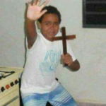 Kid holding cross, scared  Reaction meme template