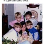 wholesome-memes cute text: A mom helping her kids beat a hard level in Super Mario Land, 1990s.  cute
