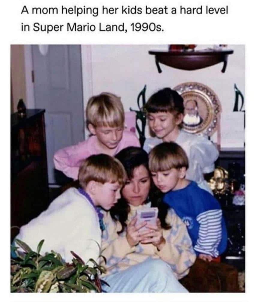 cute wholesome-memes cute text: A mom helping her kids beat a hard level in Super Mario Land, 1990s. 