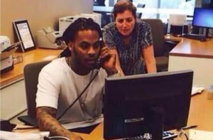 Black man helping white woman with computer Phone meme template
