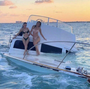 Beautiful women on sinking boat Stock Photo meme template