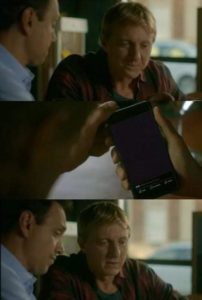 Daniel showing Johnny something on his phone Johnny Lawrence meme template