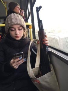 Girl on bus with AK-47 IRL meme template