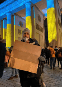 Ukrainian protester holding sign Ukraine Uniform search meme template